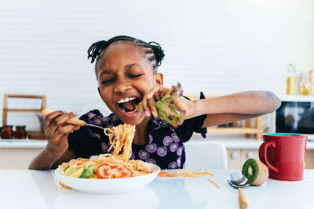 istock Hispanic girl eating spaghetti 1474941041
