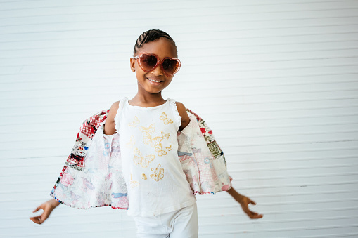 Girl wearing sunglasses against white background