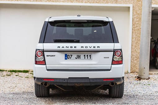 Side, Turkey – February 04 2023:    white Land Rover Range Rover Sport  is parked  on the street on a warm day