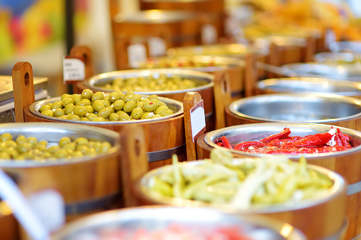Assorted organic pickled olives, garlic, hot peppers, capers and sundried tomatos sold on a marketplace in Vilnius, Lithuania, during traditional spring fair.