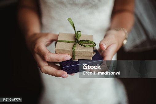 istock Bride holding gifts in her hands 1474946774
