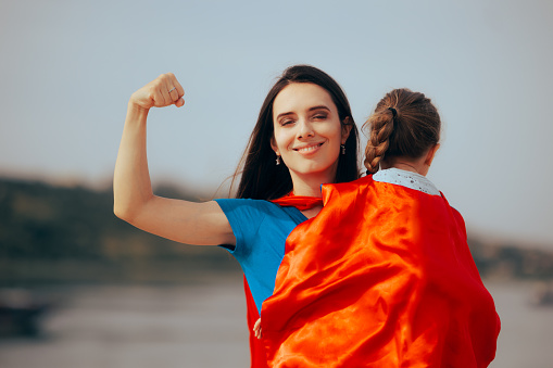 Loving mother and daughter feeling like superheroes together