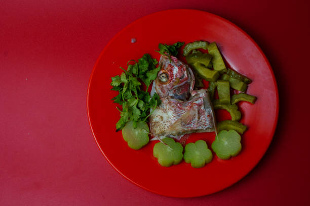 Steamed red snapper head with bitter gourds and chayotes stock photo