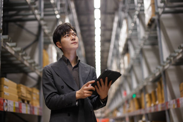 istock Man working in a warehouse via digital tablet 1474949552