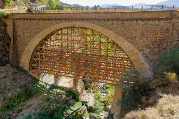 istock stone bridge with wooden reinforcements at the bottom 1474952376