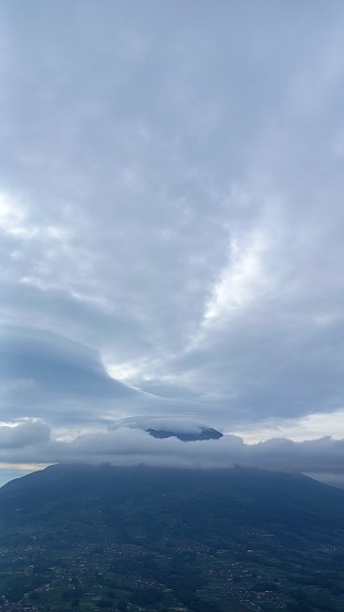 a high mountain covered with clouds