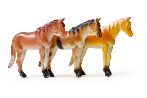 istock Three statuettes of a horse on a white background. 1474953299