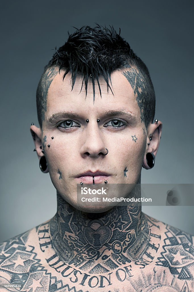 Tattoo artist portrait Portrait of a young man with a lot of tattoos and piercings Pierced Stock Photo