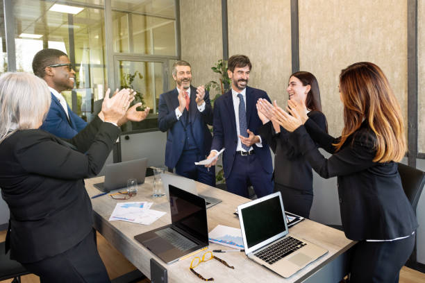 istock Group of multiethnic colleagues clapping hands in office 1474959433