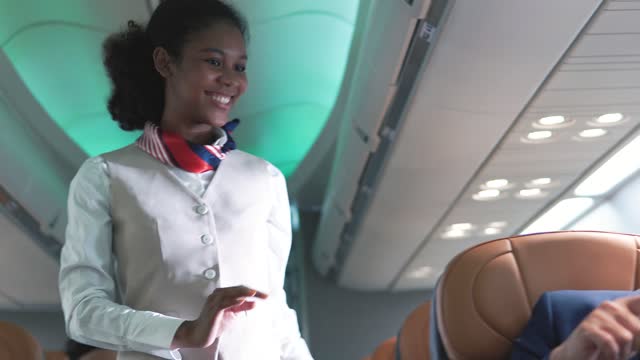 Air hostess welcoming passengers into the plane