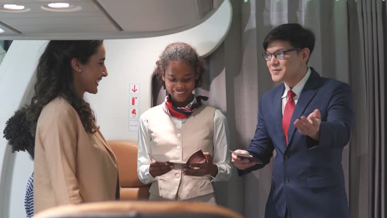 Air hostess welcoming passengers into the plane