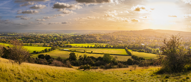 Panoramic view of English countryside from Norths Downs ridge in Surrey, England, in autumn at sunset
