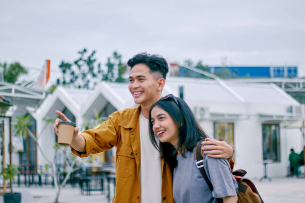 istock Happy asian couples looking away while travelling together. 1474964619