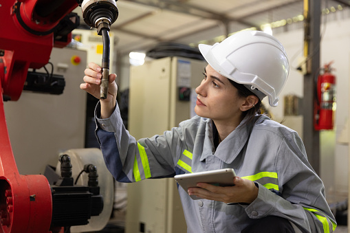 Engineer checking automatic robotic arm machine welding