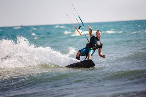 istock Young man having fun while kitesurfing on the sea. 1474973187