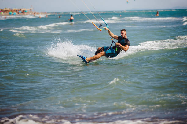 istock Young man having fun while kitesurfing on the sea. 1474973214