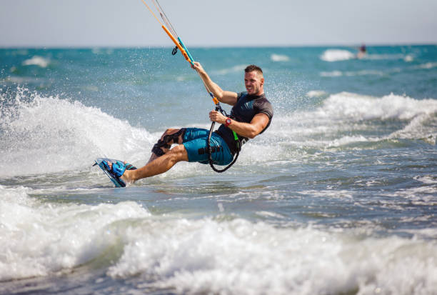 istock Young man having fun while kitesurfing on the sea. 1474973289