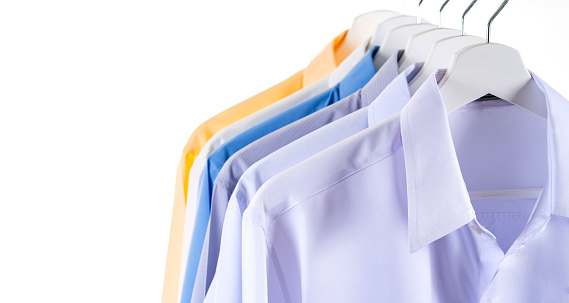 Colorful shirts hanging on a rack, background