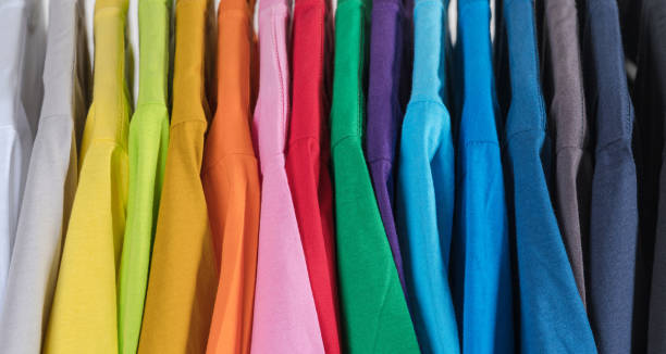 istock Colorful t-shirts hanging on a rack 1474974586