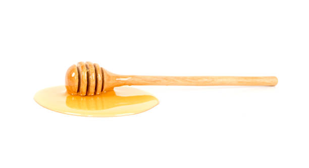 istock Honey with honey dipper on white background 1474974695