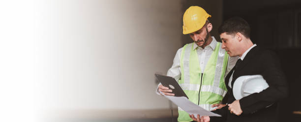 istock Civil Engineer team helmets hardhat on construction site and working together. Foreman industry project manager engineer teamwork. industry professional team 1474976352