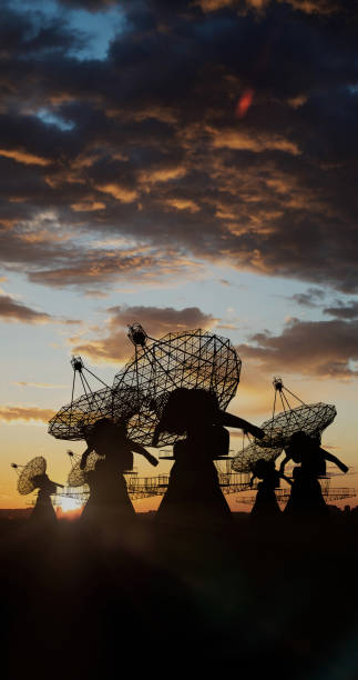 istock Large radio telescopes receiving information under a colored sunset sky 1474977367