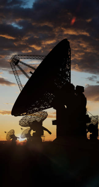 istock Radio telescopes on a field under the sunset sky 1474977396