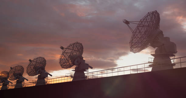 istock Satellite dishes facing up against the sunset sky 1474977492