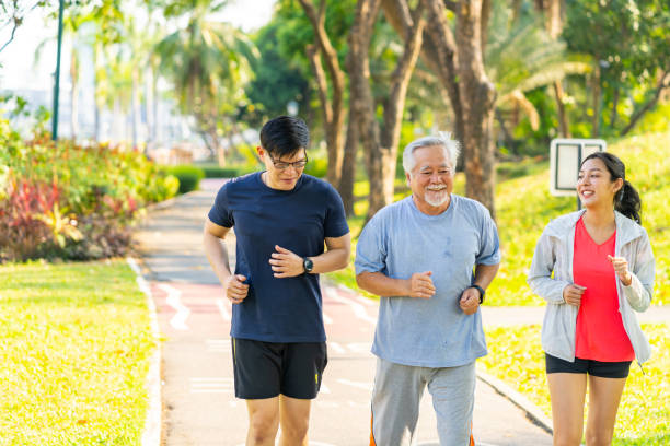 istock Asian couple and elderly father jogging exercise together at park. 1474977795