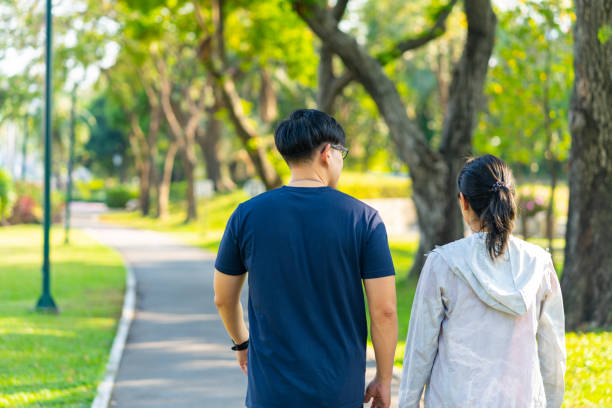 istock Asian couple jogging exercise together at public park. 1474977801