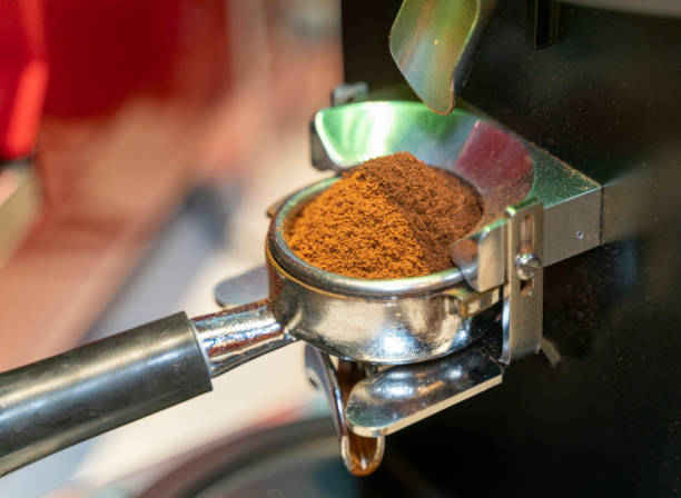 istock Coffee beans in a portafilter by the coffee grinder 1474978098