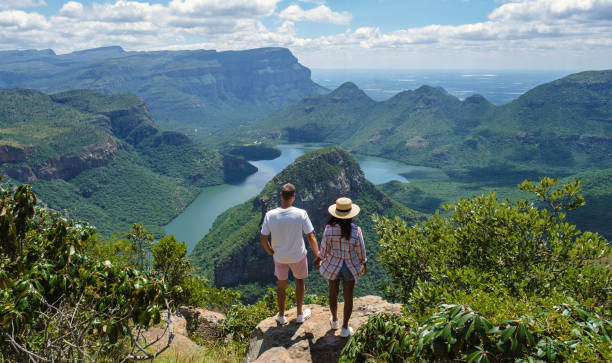 Panorama Route South Africa, Blyde river canyon with the three rondavels Panorama route South Africa Panorama Route South Africa, Blyde river canyon with the three rondavels, view of three rondavels and the Blyde river canyon in South Africa. Asian women and Caucasian men on vacation in South Africa southern africa stock pictures, royalty-free photos & images