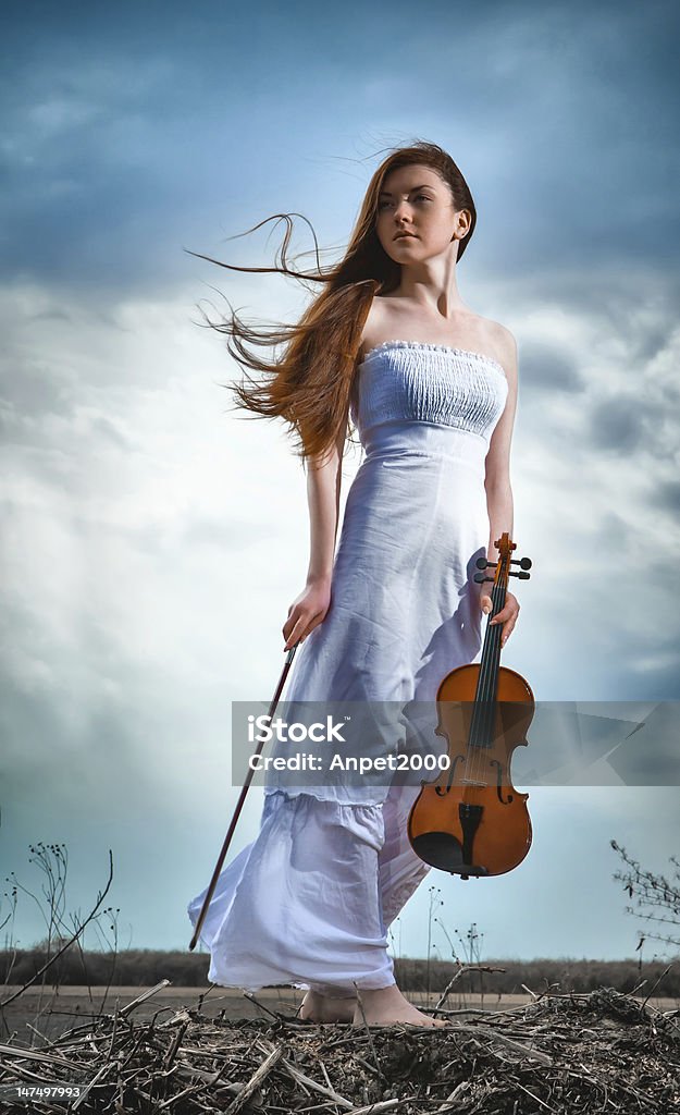 The red-haired girl with a violin outdoor Adult Stock Photo