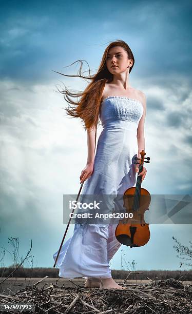 The Redhaired Girl With A Violin Outdoor Stock Photo - Download Image Now - Adult, Blue, Fantasy
