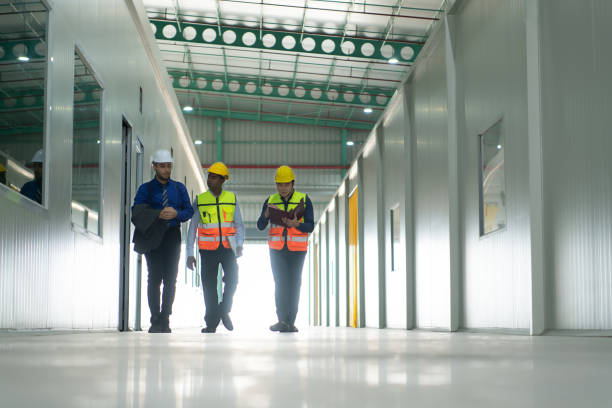 istock The warehouse manager advises the two employees 1474981414