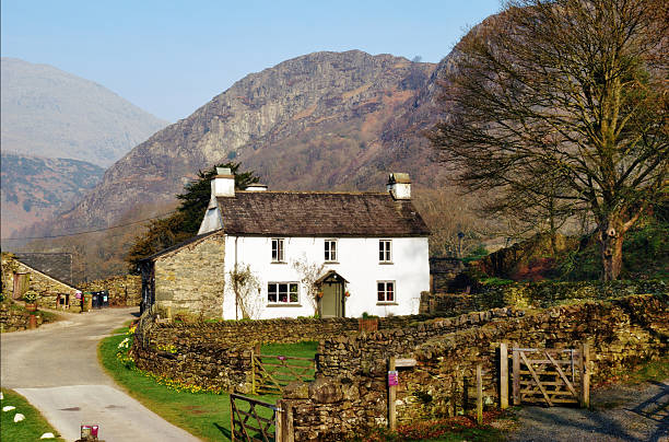 Farmhouse cottage on Yew Tree Farm Farmhouse cottage on Yew Tree Farm in the English Lake District was once the home of Beatrix Potter who bequeathed it to the National Trust in her will english lake district stock pictures, royalty-free photos & images