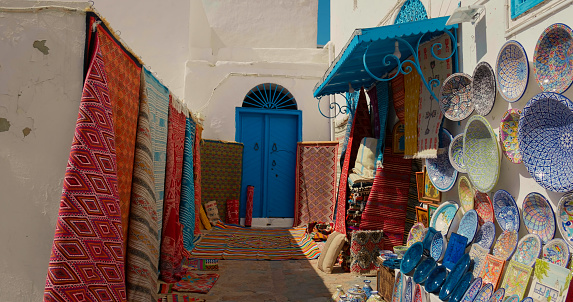 Multicolor Souvenir earthenware and carpets in tunisian market, Sidi Bou Said, Tunisia.
