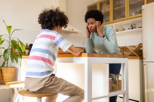 istock Black mother feeling frustrated while talking to her son at home. 1474983026