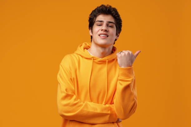 istock Young handsome man over blue background pointing to the side 1474983280