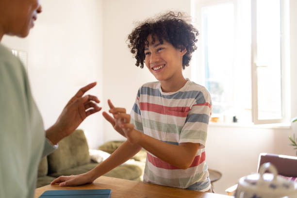 istock Happy black boy enjoying while communicating with his single mother at home. 1474983415