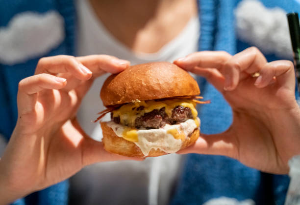 istock Woman eating beef burger 1474984407