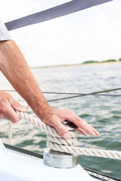 istock Caucasian Yachtsman Hands Dealing with Yacht Ropes. 1474986339