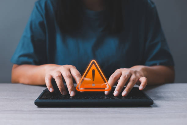 istock Businesswoman hands on computer keyboard got warning sign icon with virtual screen. Warning or alert software, virus or threat online, caution icon, malicious cyber attack on internet technology. 1474988507