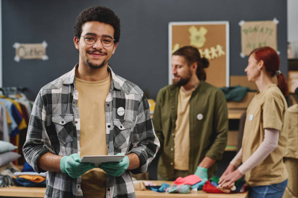 istock Happy young multi-ethnic male volunteer holding tablet 1474989719