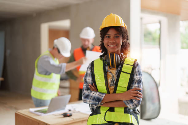 istock Foreman builder woman at construction site. American African foreman construction standing at construction site 1474992214
