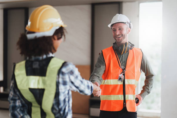 istock Architect or engineer and foreman construction workers shaking hands after finish an agreement in the office construction site, success collaboration concept 1474993106