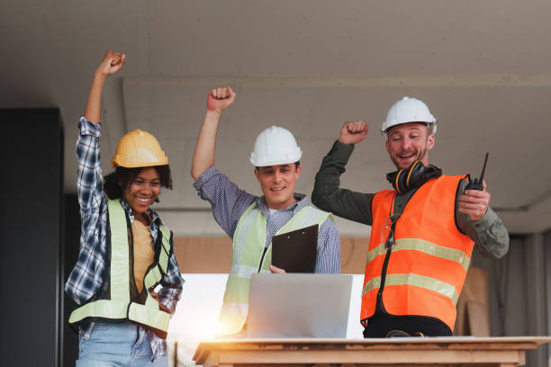 istock Engineer and Architecture and Foreman celebrate success at construction site. Industrial people and manufacturing labor concept 1474993686