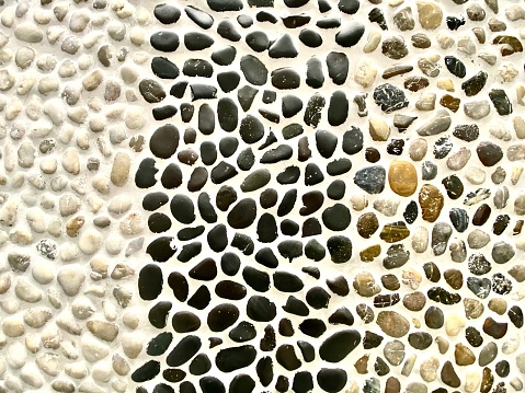 Group of ceramic tiles made of different kinds of river stones: white, black and mixed natural colors