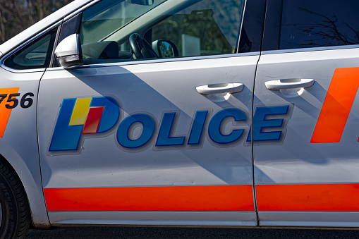 Side view of parked police car at town square named Nations at Swiss City of Geneva on a sunny late winter day. Photo taken March 5th, 2023, Geneva, Switzerland.