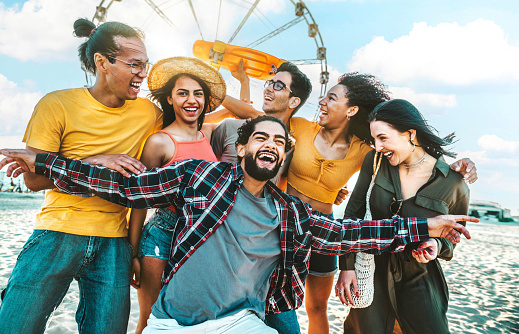 Happy multiracial friends enjoying beach party at summer vacation - Life style concept with guys and girls hanging out on city street - Millenial people having fun outside - Bright color